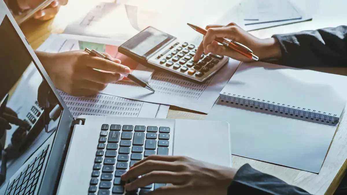 Accountant reconciling the bank statement against the internal floor plan record